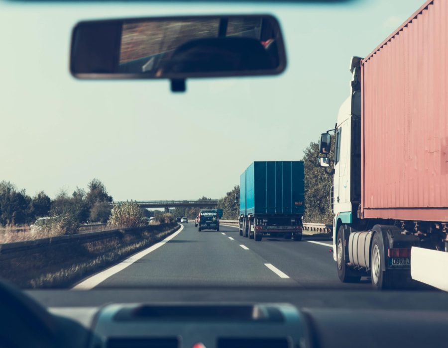 View through rearview mirror of trucks on a German highway, driving towards Bamberg.